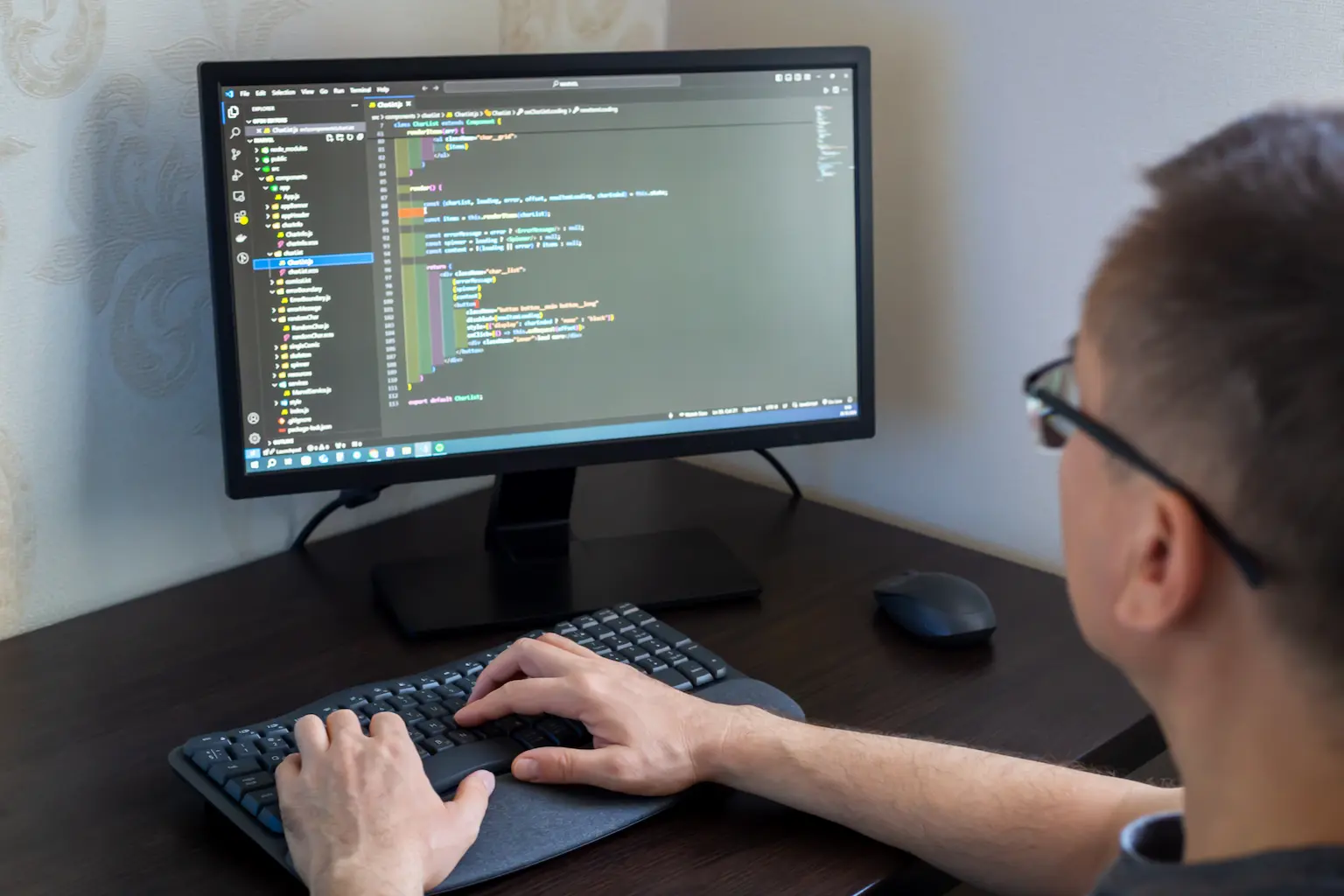 3X Web design Agency developer coding a website on a desktop computer, focused on building, testing, and optimizing fast, secure, scalable web experiences